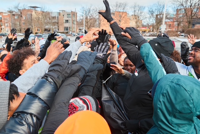 Peace Runners team hands raised in a huddle
